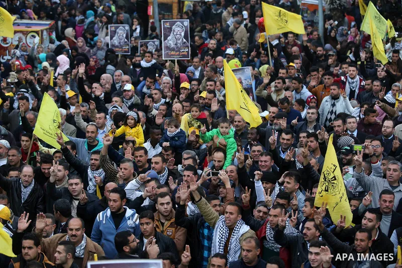 Palestinian supporters of the Fatah movement take part during a rally in Gaza City on December 31, 2017, marking the 53rd anniversary of the creation of the political party. Photo by Ashraf Amra