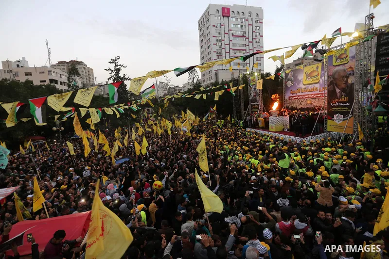 Palestinian supporters of the Fatah movement take part during a rally in Gaza City on December 31, 2017, marking the 53rd anniversary of the creation of the political party. Photo by Ashraf Amra