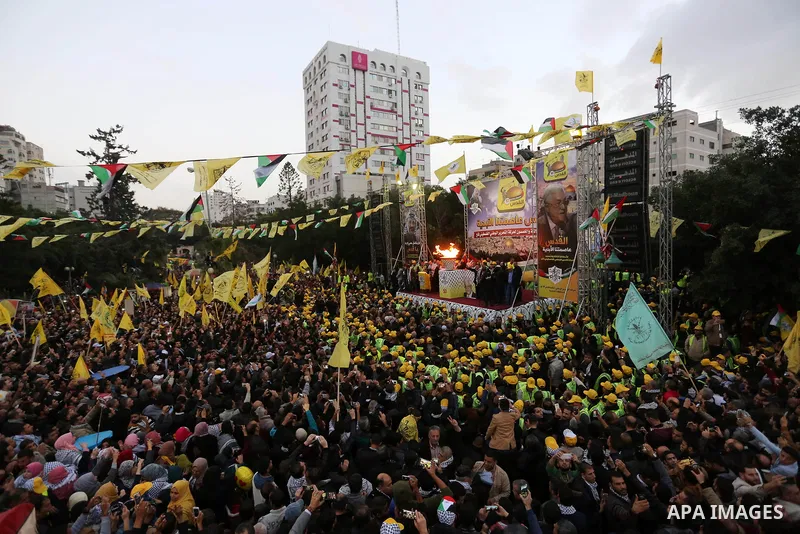 Palestinian supporters of the Fatah movement take part during a rally in Gaza City on December 31, 2017, marking the 53rd anniversary of the creation of the political party. Photo by Ashraf Amra