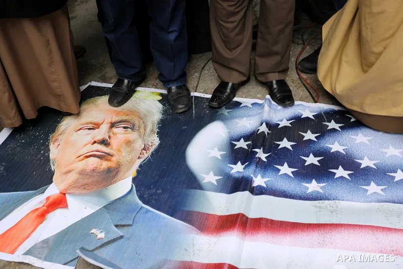 Palestinian supporters of Islamic Jihad movement step on a poster depicting U.S. President Donald Trump during a protest against his decision to recognise Jerusalem as the capital of Israel, in Khan Younis in the souther...