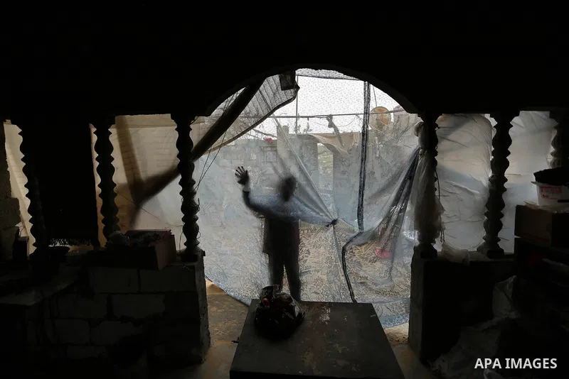 A Palestinian boy plays outside his family house on a stormy day in Khan Younis in the southern Gaza Strip January 5, 2018. Palestinian department of Meteorology warned people against gusty winds that could reach 90 km/h...