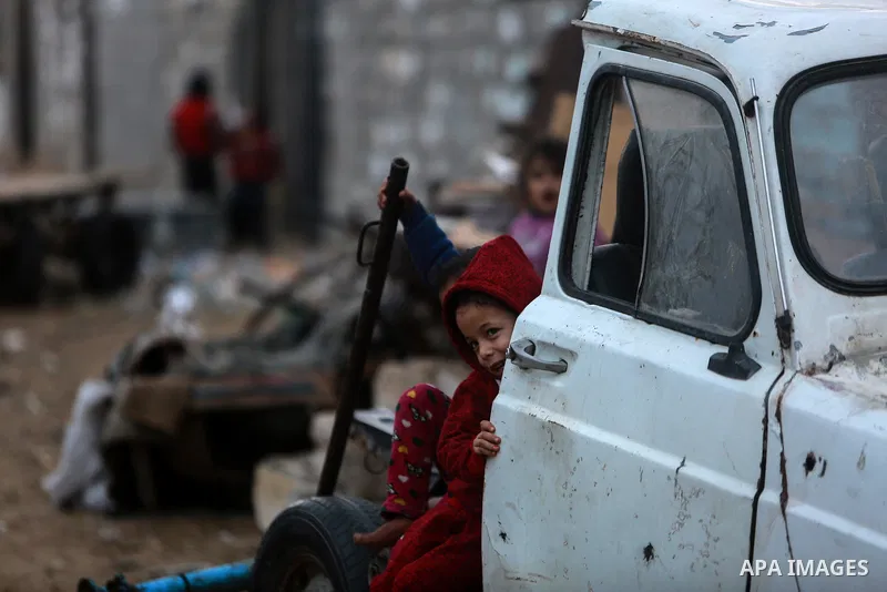 Palestinian children play outside their house on a stormy day in Khan Younis in the southern Gaza Strip January 5, 2018. Palestinian department of Meteorology warned people against gusty winds that could reach 90 km/hour...