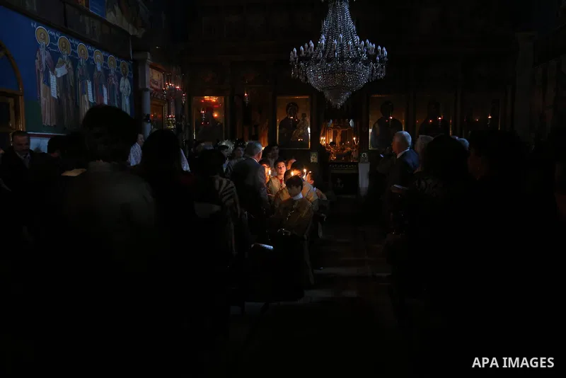 Palestinian Greek Orthodox Christians attend Christmas mass at the Orthodox Saint Porfirios church in Gaza City on January 7, 2018. The Orthodox Church celebrates Christmas and other religious holidays according to the J...