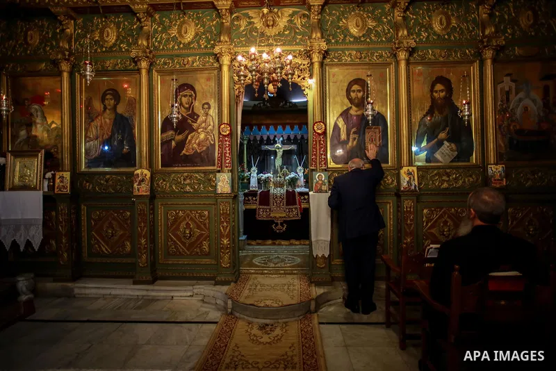 Palestinian Greek Orthodox Christians attend Christmas mass at the Orthodox Saint Porfirios church in Gaza City on January 7, 2018. The Orthodox Church celebrates Christmas and other religious holidays according to the J...