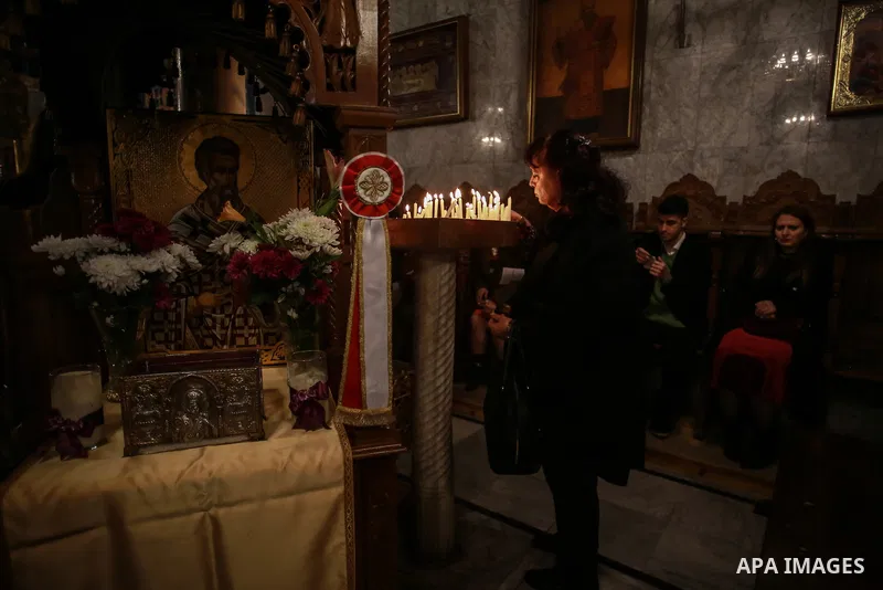 Palestinian Greek Orthodox Christians attend Christmas mass at the Orthodox Saint Porfirios church in Gaza City on January 7, 2018. The Orthodox Church celebrates Christmas and other religious holidays according to the J...