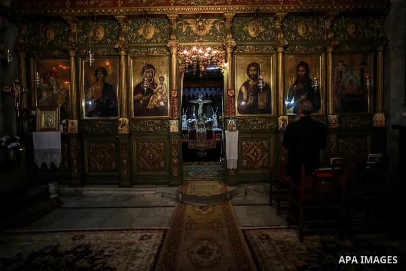 Palestinian Greek Orthodox Christians attend Christmas mass at the Orthodox Saint Porfirios church in Gaza City on January 7, 2018. The Orthodox Church celebrates Christmas and other religious holidays according to the J...