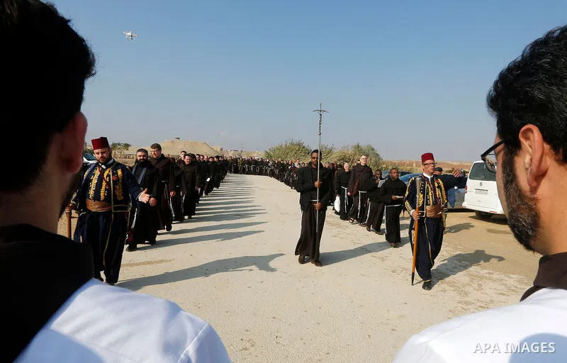 Custodian of the Holy Land Father Francesco Patton visits the waters of the Jordan River during a ceremony re-enacting Jesus' baptism at the baptismal site known as Qasr el-Yahud, near the West Bank city of Jericho Janua...