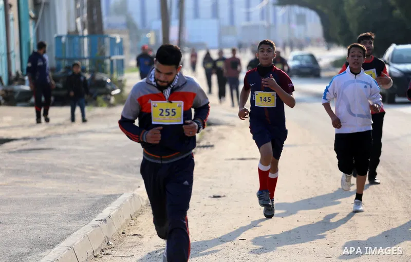 Palestinian youths take part in a running marathon "Jerusalem is the Capital of Palestine" which organized by Fatah movement in Gaza City on January 7, 2018. Photo by Mohammed Asad