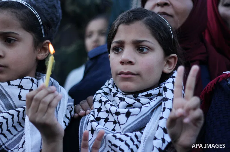 A Palestinian girl holds a candle during a protest in support of Palestinian teenager Ahed Tamimi, 16-year-old in Gaza city on January 8, 2018. Israel charged Tamimi with 12 counts including assault on January 1 followin...
