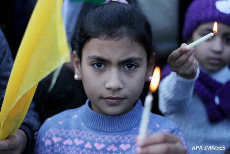 A Palestinian girl holds a candle during a protest in support of Palestinian teenager Ahed Tamimi, 16-year-old in Gaza city on January 8, 2018. Israel charged Tamimi with 12 counts including assault on January 1 followin...
