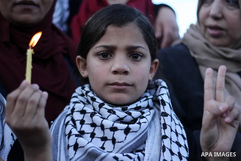 A Palestinian girl holds a candle during a protest in support of Palestinian teenager Ahed Tamimi, 16-year-old in Gaza city on January 8, 2018. Israel charged Tamimi with 12 counts including assault on January 1 followin...