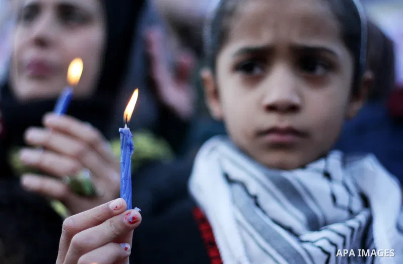 A Palestinian girl holds a candle during a protest in support of Palestinian teenager Ahed Tamimi, 16-year-old in Gaza city on January 8, 2018. Israel charged Tamimi with 12 counts including assault on January 1 followin...