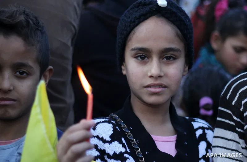 A Palestinian girl holds a candle during a protest in support of Palestinian teenager Ahed Tamimi, 16-year-old in Gaza city on January 8, 2018. Israel charged Tamimi with 12 counts including assault on January 1 followin...