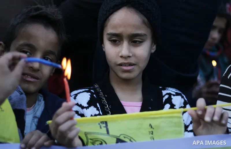 A Palestinian girl holds a candle during a protest in support of Palestinian teenager Ahed Tamimi, 16-year-old in Gaza city on January 8, 2018. Israel charged Tamimi with 12 counts including assault on January 1 followin...