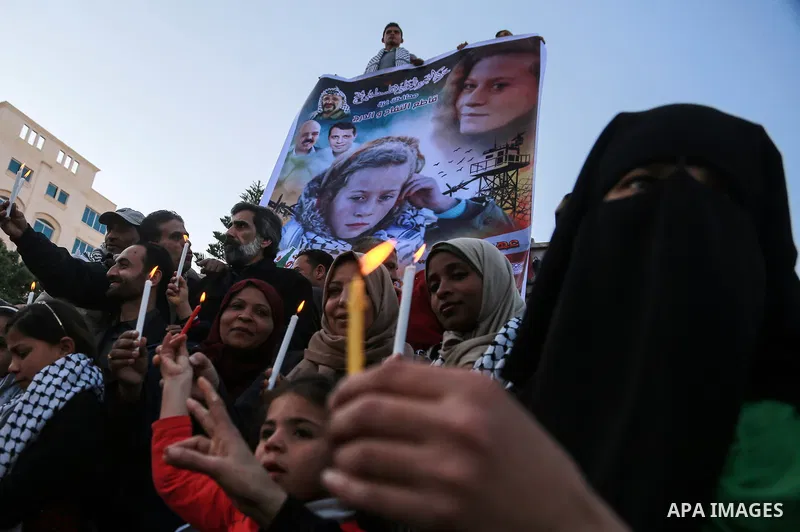 Palestinians hold candles during a protest in support of Palestinian teenager Ahed Tamimi, 16-year-old in Gaza city on January 8, 2018. Israel charged Tamimi with 12 counts including assault on January 1 following her ar...