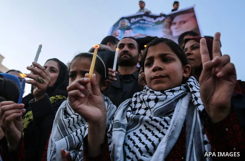 Palestinian children hold candles during a protest in support of Palestinian teenager Ahed Tamimi, 16-year-old in Gaza city on January 8, 2018. Israel charged Tamimi with 12 counts including assault on January 1 followin...