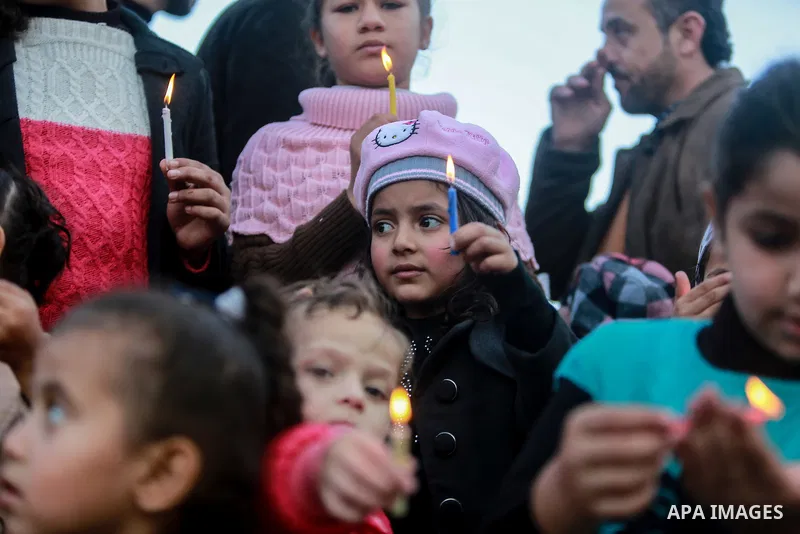 Palestinian children hold candles during a protest in support of Palestinian teenager Ahed Tamimi, 16-year-old in Gaza city on January 8, 2018. Israel charged Tamimi with 12 counts including assault on January 1 followin...
