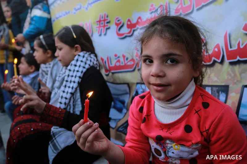 Palestinian children hold candles during a protest in support of Palestinian teenager Ahed Tamimi, 16-year-old in Gaza city on January 8, 2018. Israel charged Tamimi with 12 counts including assault on January 1 followin...