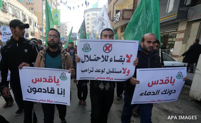 Palestinians hold national flags during a protest against U.S. President Donald Trump's decision to recognise Jerusalem as the capital of Israel, in Gaza city on January 9, 2018. Photo by Mohammed Asad