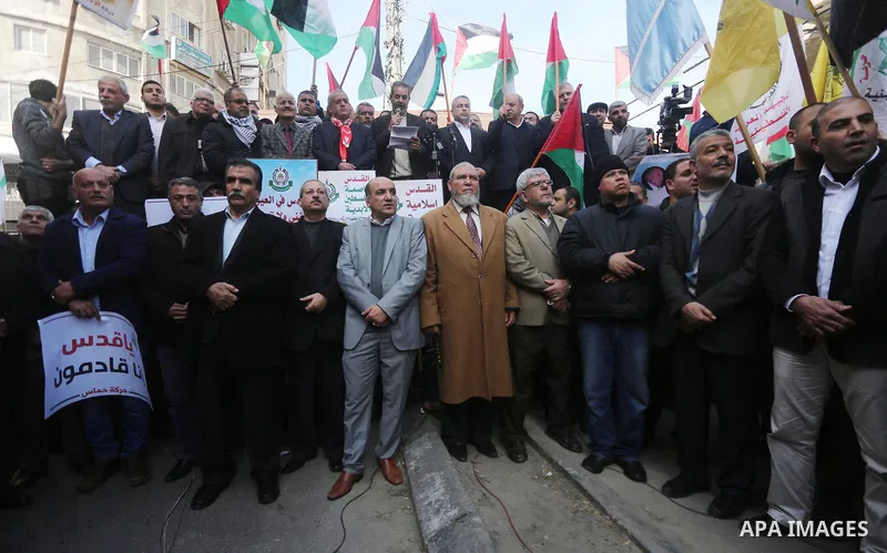 Palestinians hold national flags during a protest against U.S. President Donald Trump's decision to recognise Jerusalem as the capital of Israel, in Gaza city on January 9, 2018. Photo by Mohammed Asad