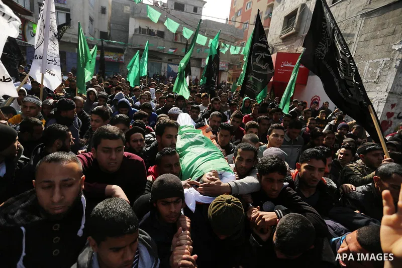 Palestinian mourners carry the body of Amir Abu Musaid, 16, during his funeral in the al-Maghazi refugee camp, in the centre of the Gaza Strip, after he was shot dead in clashes with the Israeli military along the Gaza b...