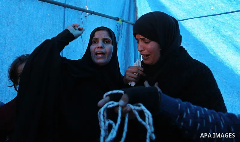 Palestinian relatives of Amir Abu Musaid, 16, mourn during his funeral in the al-Maghazi refugee camp, in the centre of the Gaza Strip, after he was shot dead in clashes with the Israeli military along the Gaza border th...