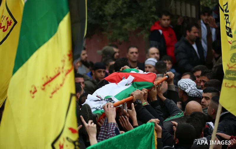Palestinian mourners carry the body of Ali Omar Qino, 16, during his funeral at the village of Burin near the West Bank city of Nablus, on January 12, 2018. Two Palestinian teenagers were shot dead in clashes with Israel...