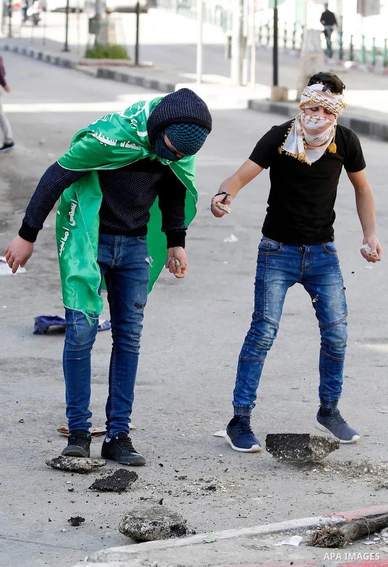 Palestinian protesters clash with Israeli security forces following a demonstration against the US president's decision to recognise Jerusalem as the capital of Israel, in the West Bank city of Hebron on January 12, 2018...