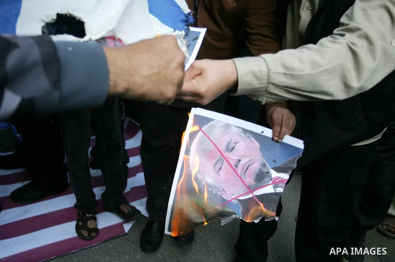 Palestinian supporters of the Islamic Jihad movement burn an Israeli flag and a portrait of US President Donald Trump during a protest against Trumps's decision to recognise Jerusalem as the capital of Israel, in the tow...