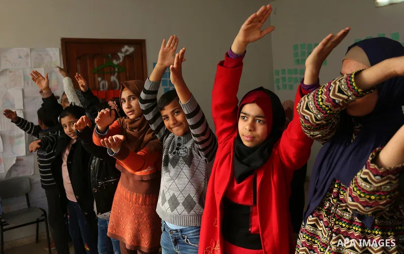 Palestinian children take a yoga lesson which organized by the center for Mind- Body Medicine, in Gaza city on January 10, 2018. The Center for Mind-Body Medicine is a non- profit, educational organization founded in Was...