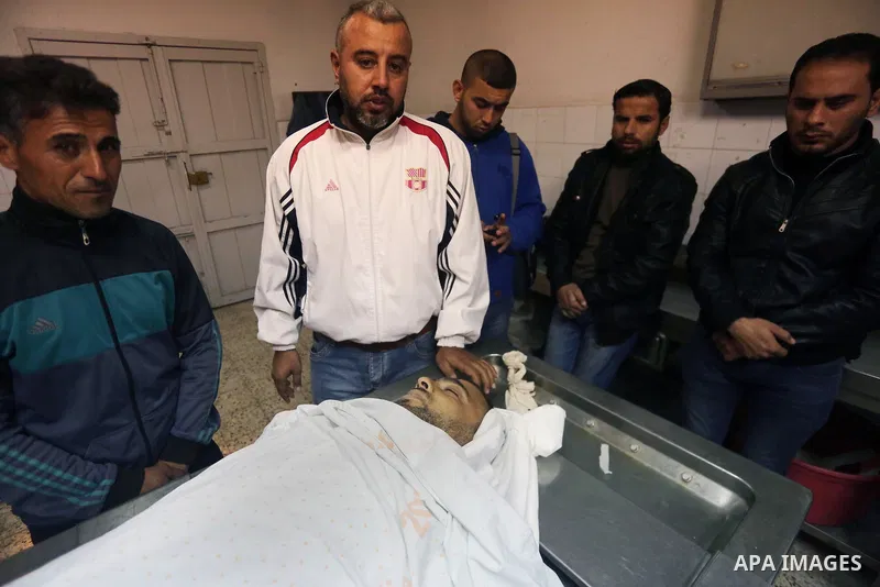 Relatives of a Palestinian fisherman Abdullah Ramadan Zidan, 33, who died of his injuries after Egyptian Navy shot him last night mourn over his body at al-Shifa hospital in Gaza City on January 13, 2018. Photo by Mohamm...