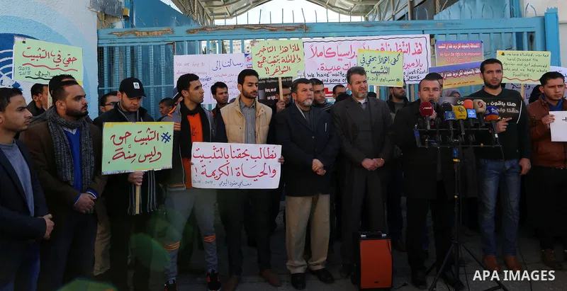Palestinian teachers take part in a protest demanding their rights in front of the headquarters United Nations Relief and Works Agency (UNRWA), in Gaza City, on January 14, 2018. Photo by Yasser Qudih