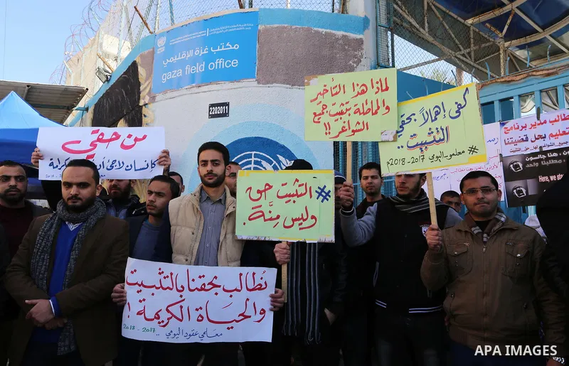 Palestinian teachers take part in a protest demanding their rights in front of the headquarters United Nations Relief and Works Agency (UNRWA), in Gaza City, on January 14, 2018. Photo by Yasser Qudih