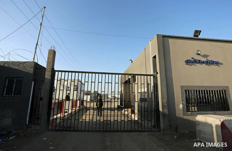 Palestinian security men stand outside Kerem Shalom, the main passage point for goods entering Gaza, after it was shut down by Israel, following the discovery of smuggling tunnels underneath the crossing, in the southern...