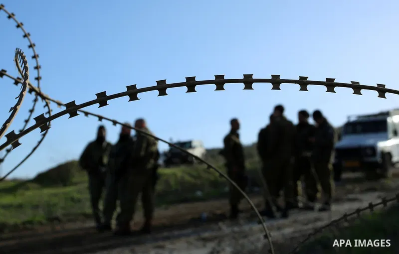 Israeli security forces stand guard during dredging Palestinian lands at the village of Burin near the West Bank city of Nablus, on January 14, 2018. Photo by Shadi Jarar'ah