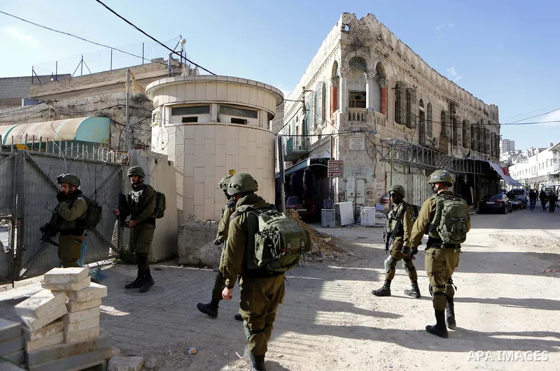 Israeli security forces patrol in the Old town in the West Bank city of Hebron on January 14, 2018. Photo by Wisam Hashlamoun