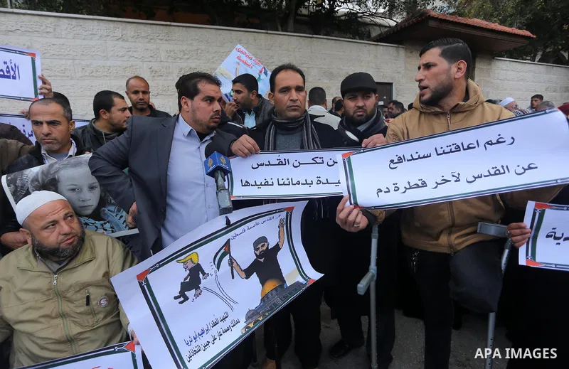 Palestinians take part in a protest against the US president's decision to recognise Jerusalem as the capital of Israel in front of Red Cross office, in Gaza city on January 15, 2018. Photo by Mohammed Asad