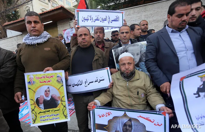 Palestinians take part in a protest against the US president's decision to recognise Jerusalem as the capital of Israel in front of Red Cross office, in Gaza city on January 15, 2018. Photo by Mohammed Asad