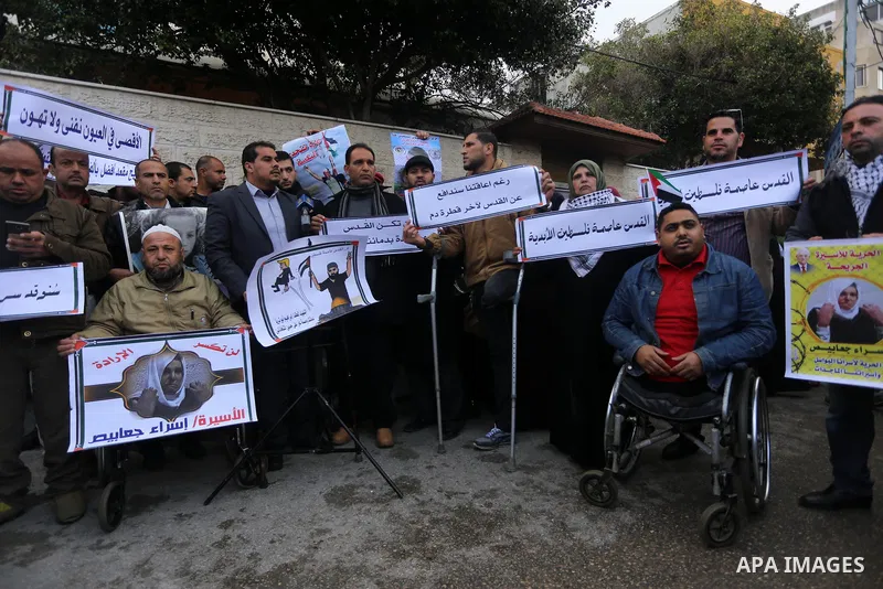 Palestinians take part in a protest against the US president's decision to recognise Jerusalem as the capital of Israel in front of Red Cross office, in Gaza city on January 15, 2018. Photo by Mohammed Asad