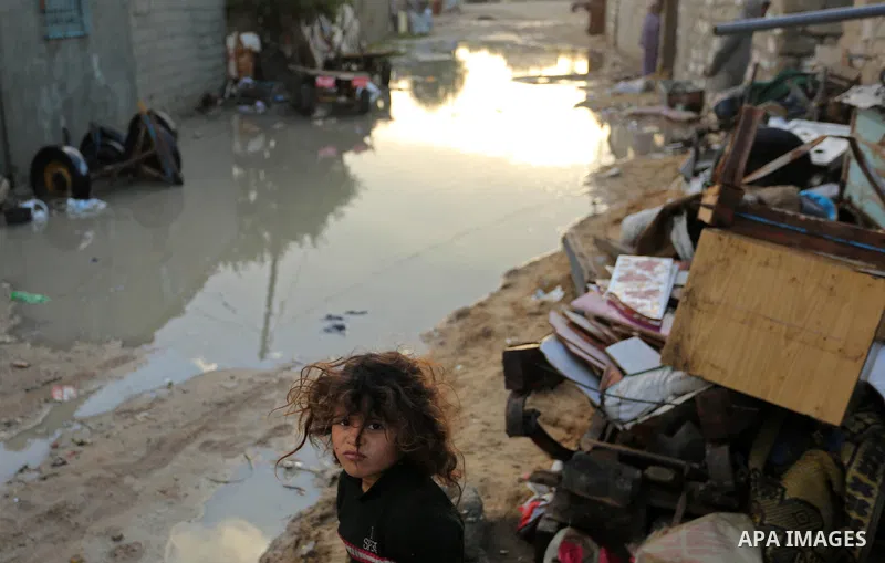 Palestinians stand outside their dwellings in Khan Younis in the southern Gaza Strip January 15, 2018. Photo by Ashraf Amra
