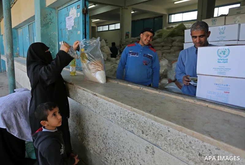 Palestinian refugees wait to receive aid at a United Nations food distribution center in Khan Younis in the southern Gaza Strip January 15, 2018. U.S. President Donald Trump is preparing to withhold tens of millions of d...