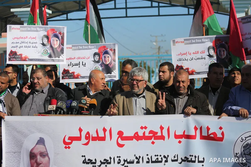 Palestinian members of National and Islamic forces take part in a protest of solidarity with prisoner Esraa Al-Jabbais held in Israeli jails in the northern Gaza Strip, on January 16, 2018. Photo by Mohammed Asad