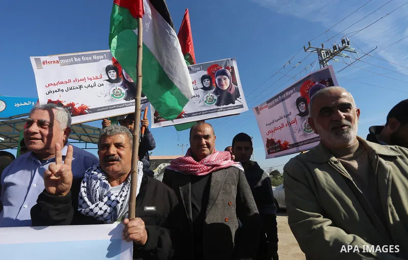 Palestinian members of National and Islamic forces take part in a protest of solidarity with prisoner Esraa Al-Jabbais held in Israeli jails in the northern Gaza Strip, on January 16, 2018. Photo by Mohammed Asad