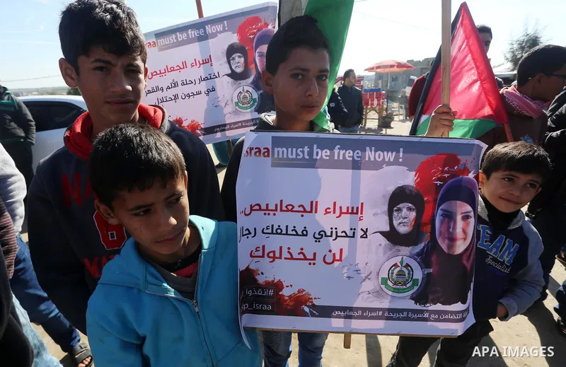 Palestinian members of National and Islamic forces take part in a protest of solidarity with prisoner Esraa Al-Jabbais held in Israeli jails in the northern Gaza Strip, on January 16, 2018. Photo by Mohammed Asad