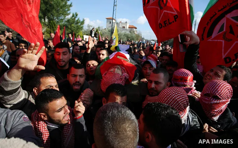 Palestinian mourners carry the body of Ahmad Saleem who was shot dead during clashes with Israeli security foces on the previous day during his funeral in the West Bank village of Jayous near Qalqilya January 16, 2018. P...