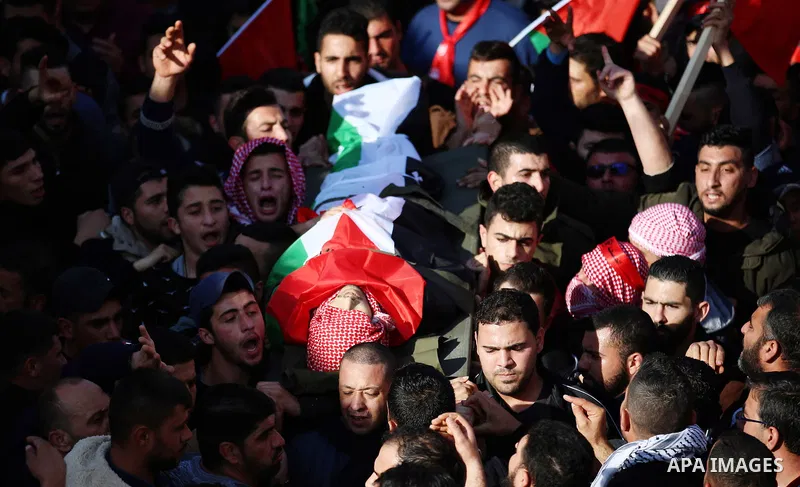 Palestinian mourners carry the body of Ahmad Saleem who was shot dead during clashes with Israeli security foces on the previous day during his funeral in the West Bank village of Jayous near Qalqilya January 16, 2018. P...