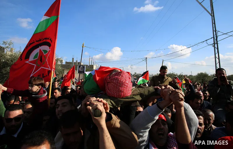 Palestinian mourners carry the body of Ahmad Saleem who was shot dead during clashes with Israeli security foces on the previous day during his funeral in the West Bank village of Jayous near Qalqilya January 16, 2018. P...