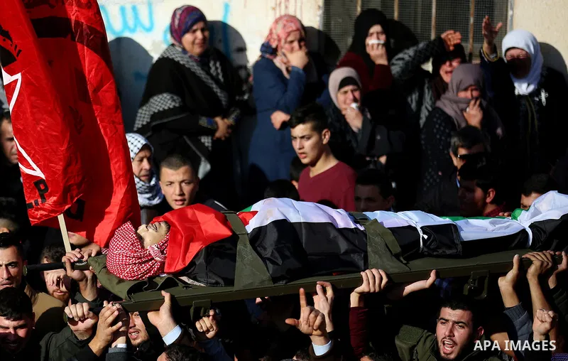 Palestinian mourners carry the body of Ahmad Saleem who was shot dead during clashes with Israeli security foces on the previous day during his funeral in the West Bank village of Jayous near Qalqilya January 16, 2018. P...