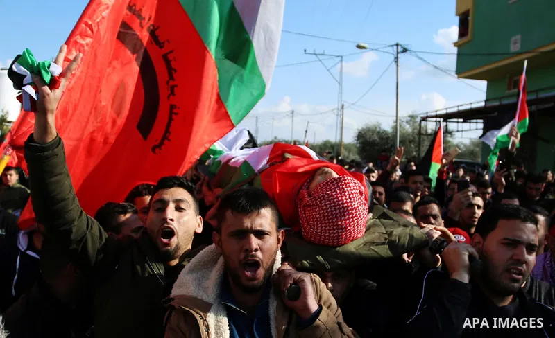 Palestinian mourners carry the body of Ahmad Saleem who was shot dead during clashes with Israeli security foces on the previous day during his funeral in the West Bank village of Jayous near Qalqilya January 16, 2018. P...