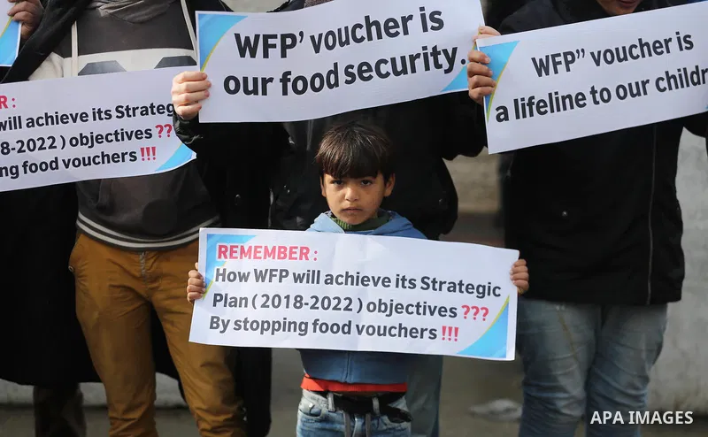 Palestinians hold banners during a protest against aid cut, in front of United Nations Development Programme office (UNDP), in Gaza City January 17, 2018. Photo by Mohammed Asad